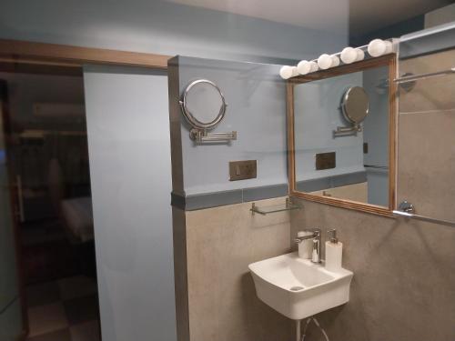 a bathroom with a sink and two mirrors at NeXstage Terraces, The Blue Lagoon Suite, Carter Road, Bandra West in Mumbai