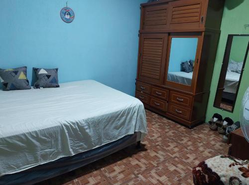 1 dormitorio con cama, tocador y espejo en Pequeña habitacion Amatitlan, en Amatitlán