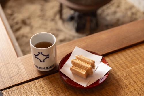 a plate of waffles on a table with a cup of coffee at 杜人舎 Morito-Sha in Nanto