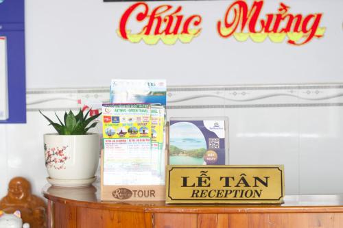 a table with a box of milk and a sign on it at Duong Hieu Guesthouse in Phu Quoc