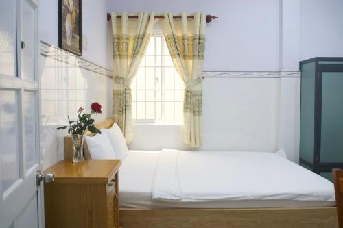 a bedroom with a bed and a window at Duong Hieu Guesthouse in Phu Quoc