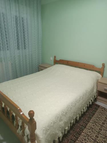 a bed in a bedroom with a white mattress at Kipseli 1 in Kozani