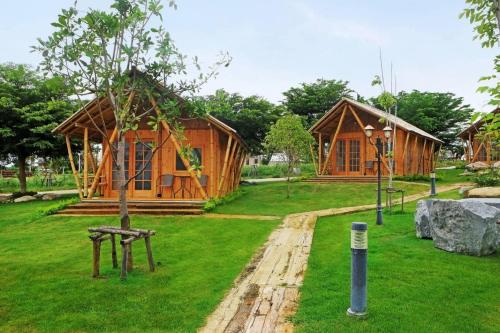 a wooden house with a playground in a park at Tayama Farm Khaoyai in Nakhon Ratchasima