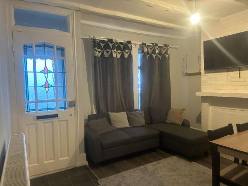 a living room with a couch and a window at Prime Alexandra Place in Chatham