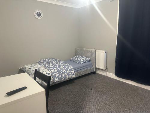 a small bedroom with a bed and a desk at Prime Alexandra Place in Chatham