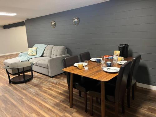 a dining room with a table and a couch at Ambrosia Studio in Winnipeg