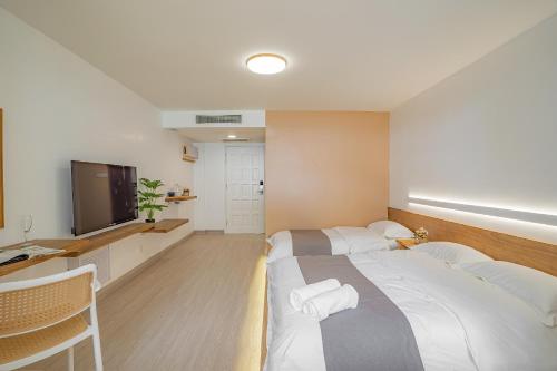 a hotel room with a large bed and a television at BIDONG VIEW RESORT in Kuala Terengganu