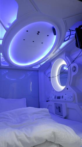 a room with a bed and a round window at Astropods in Mumbai
