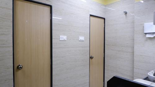 two elevators in a bathroom with a toilet at Astropods in Mumbai