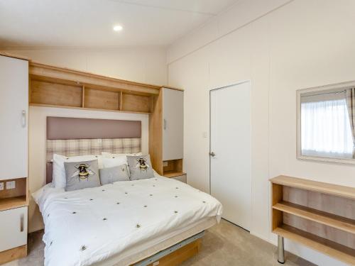 a bedroom with a large bed and a window at Roseberry Topping - Uk42937 in Great Broughton