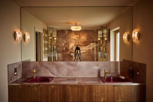 a bathroom with two red sinks in front of a mirror at Cromer Luxury Palm Springs Bungalow with Pool Room in Overstrand