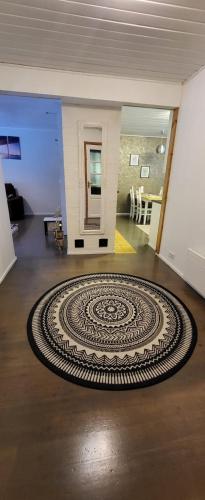 a large spiral rug on a floor in a room at 3 bedrooms, sauna and kitchen All house in Pori