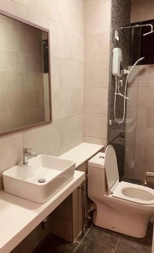 a bathroom with a sink and a toilet and a shower at Apartment in Kota Kinabalu @ The Shore in Kota Kinabalu