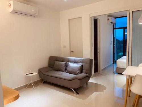 a living room with a couch and a bedroom at Apartment in Kota Kinabalu @ The Shore in Kota Kinabalu