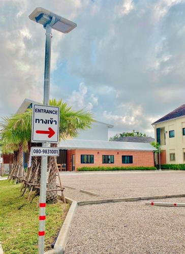 a street sign on a pole with a street light at Calamint Residence Hotel ( คาลามิ้นท์) in Chumphon