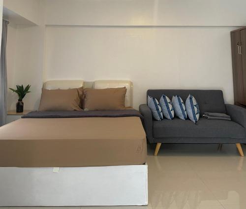 a bedroom with a bed and a couch at The Premier Suite in Pusok