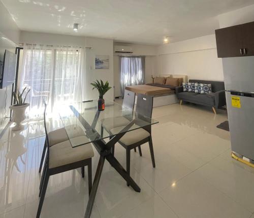a kitchen and living room with a glass table at The Premier Suite in Pusok