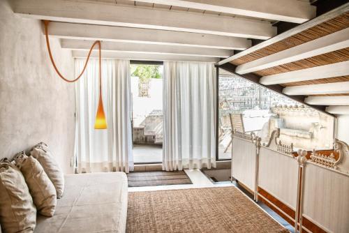 a bedroom with a bed and a large window at CASA TALIA - Rooms in Modica