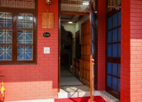 an open door of a red brick building at The Basera in Rishīkesh