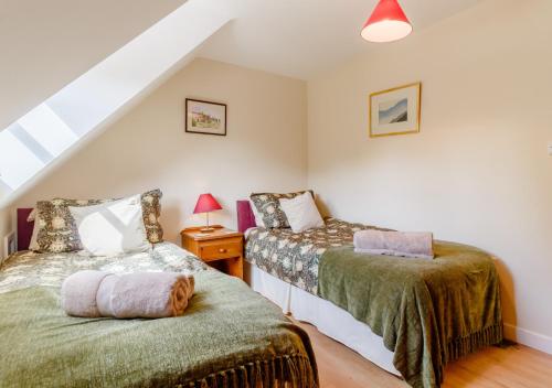 a bedroom with two beds in a attic at Vale View in Hollesley