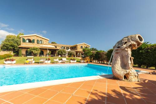 a house with a swimming pool in front of a house at Hotel Janas in Tertenìa