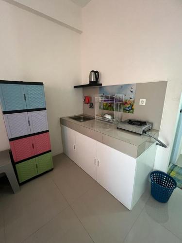 a kitchen with a counter with a sink and a counter at Ita Room Apartement Serpong Green View in Ciater-hilir