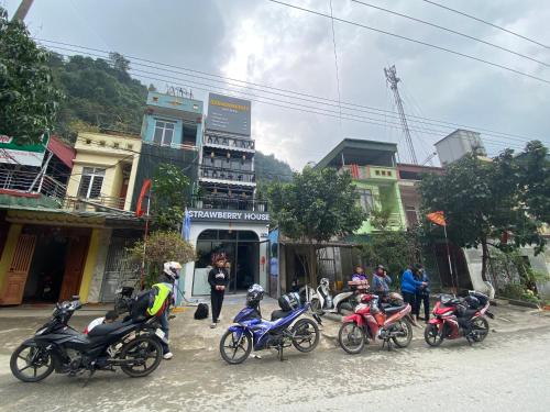 a group of motorcycles parked on a city street at Strawberry House , Tour & Motorbikes Rentel in Ha Giang
