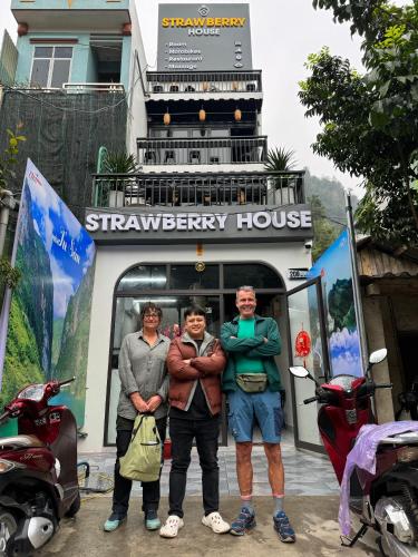 a group of three people standing in front of a building at Strawberry House , Tour & Motorbikes Rentel in Ha Giang