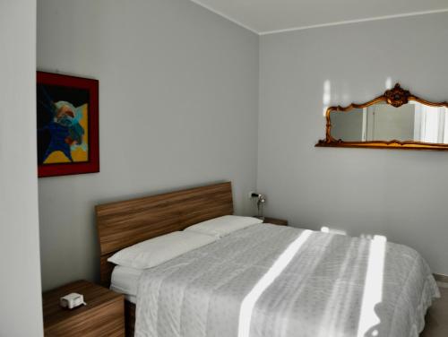 a bedroom with a bed and a mirror on the wall at MATT59 APARTMENTS in Rho