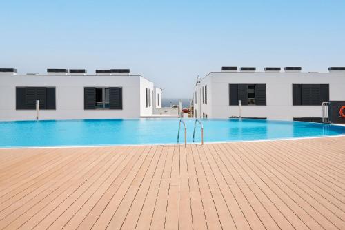a large swimming pool in the middle of a building at CASA LA BOTAVARA - Pool & Beach in Abades