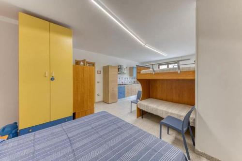 a bedroom with a bed and a yellow cabinet at A Casa di Ada, Tricase, Salento in Tricase