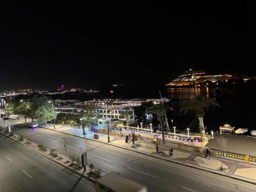 a view of a city at night with a train at Relaxation, fresh air, and a direct view of the Nile in Naj‘ al ‘Amrāb