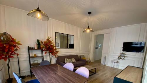 un salon avec une table et un canapé dans l'établissement Cocooning appartement à côté Champs-Elysée, à Paris