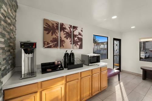 a kitchen with a counter with a microwave and a tv at Red Roof Inn Los Angeles - Bellflower in Bellflower
