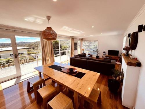 a living room with a table and a couch at The Coles Bay Shack - Freycinet in Coles Bay
