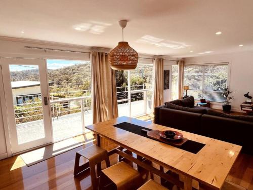 a living room with a table and a couch at The Coles Bay Shack - Freycinet in Coles Bay