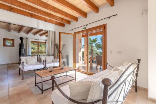 a living room with a bed and a table at Finca Es Foners in Felanitx