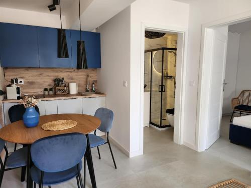 a kitchen and dining room with a table and chairs at Apartament, Wypoczynkowa Rowy in Rowy