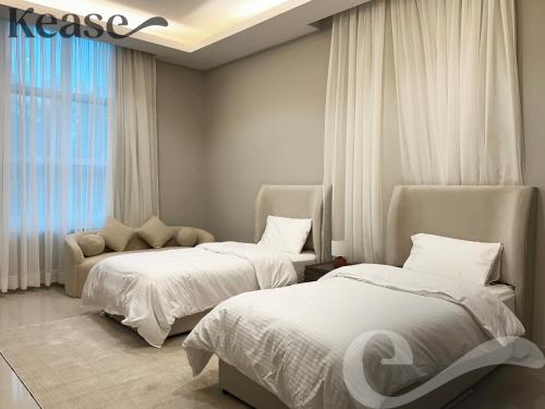 a bedroom with two beds and a window at Kease Al-Mutamarat A-14 Timeless History AG50 in Riyadh
