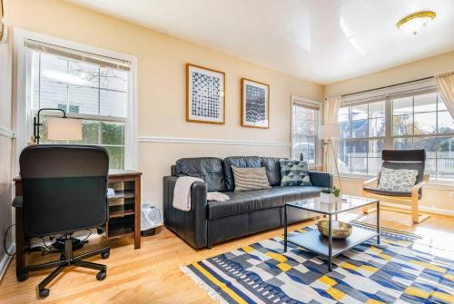 a living room with a couch and a table at Cozy House 10min to Monuments and DC by CozySuites in Arlington