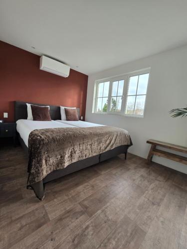 a bedroom with a large bed and a window at Tip Top vakantie Woning Vlissingen in Vlissingen
