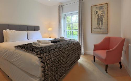 een slaapkamer met een bed, een stoel en een raam bij Period Character with Modern Comforts In Monkstown in Blackrock