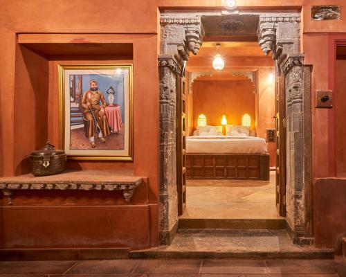 a hallway with a room with a bed and a painting at Kaladwas Lal Haveli - A Heritage Boutique Hotel in Udaipur