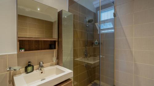 a bathroom with a sink and a shower at Exquisite 2 Bedroom, Lux Living at Riverside in Nairobi