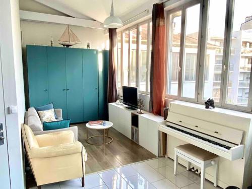 a living room with a piano and a couch at The Artist in Clichy