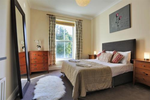 a bedroom with a large bed and a window at Walking distance to Grafton St in Dublin