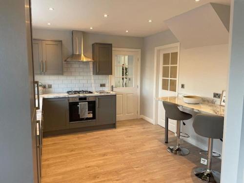 a kitchen with a stove and a counter top at Large Lytham Home - The Birds View by Holiday Heim in Lytham St Annes