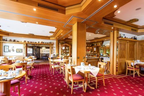 a dining room with wooden tables and chairs at Hotel Bären in Bernkastel-Kues