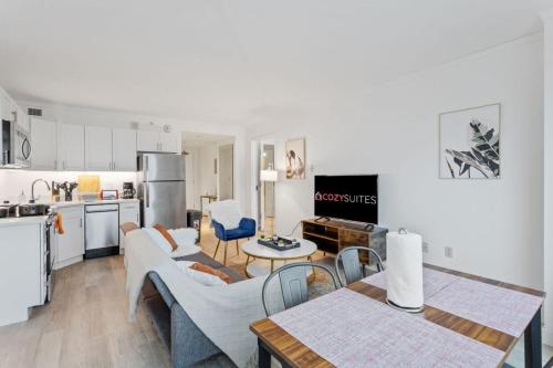 a kitchen and living room with a table and chairs at Beachfront 2BR 3BA Condo by CozySuites in Atlantic City