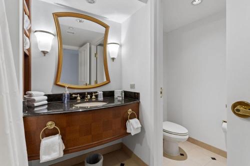 a bathroom with a sink and a mirror at Beachfront 2BR 3BA Condo by CozySuites in Atlantic City